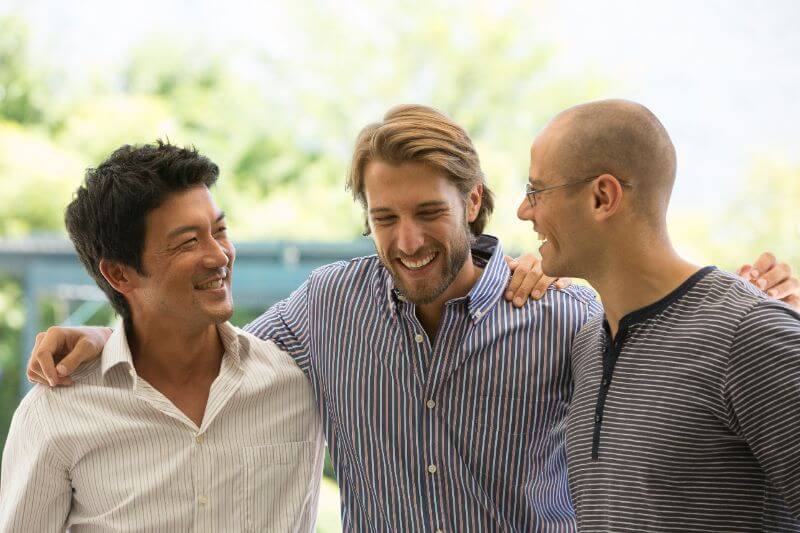Three men possibly discussing foot care for men