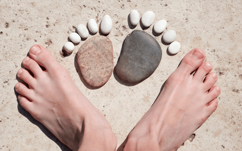 Real feet and feet made of stones to represent foot health myths