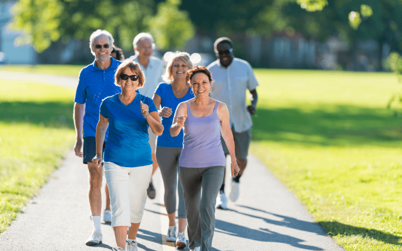 A happy group of people walking showing the importance of regular foot check-ups