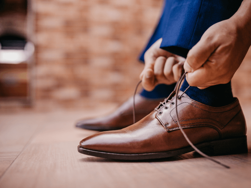 Man tying the laces on his work shoes