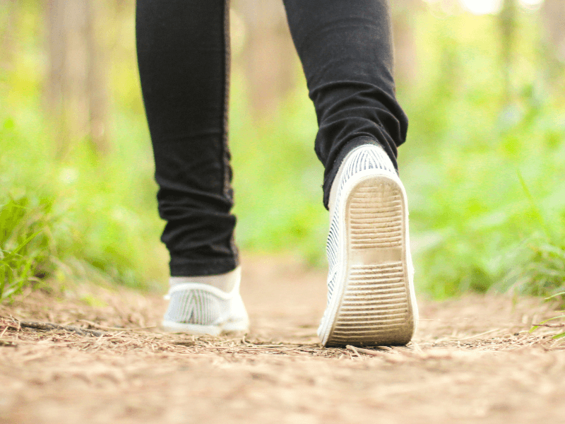 Person walking outside and possibly wondering if it’s time to replace their orthotics.